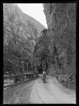 Joseph Divis with bicycle on road through Karangahake Gorge