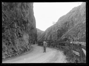 Joseph Divis with tripod and camera on road through Karangahape Gorge