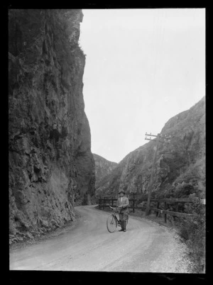 Joseph Divis with bicycle on road through Karangahake Gorge