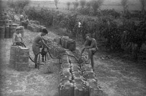 J M Collins, J J Lodge and R Hanson of NZ Div Petrol Point filling petrol cans, Italy