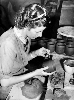 Unidentified woman attaching a handle to a newly made cup