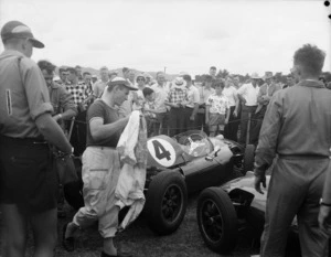 Bruce McLaren, his Cooper automobile and crowd