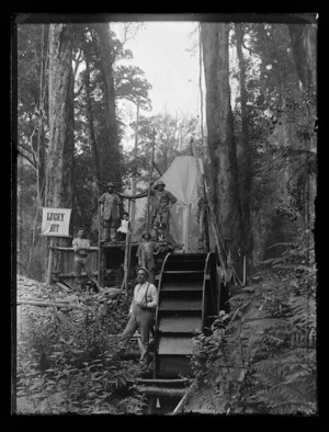 Henry Wright and miners standing outside the `Lucky Hit' mine, near Karaka Creek, Thames