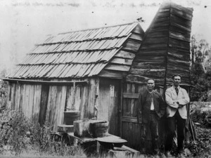 Reverend George Hunter McNeur outside a mining hut with gold miner Chan Kwie Lim