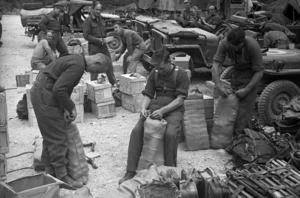 New Zealand soldiers, J A Harper, S I Merriman and R W Clarkin, packing supplies at the Hove Dump, Cassino area, Italy