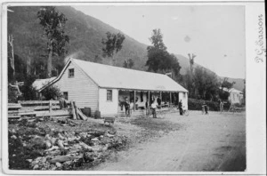 Unidentified men with cycles outside J Jackson's Perry Range Hotel, Jacksons, Westland