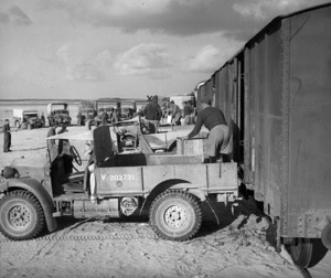 NZASC trucks drawing rations at Western Desert railhead from daily train