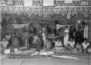 Raine, William Hall, 1892-1955 : Women demonstrating the making of tapa cloth and woven items