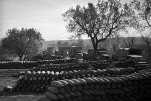 Looking over an ammunition dump at New Zealand and American military trucks, Volturno Valley, Italy