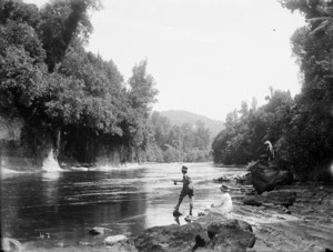 Man fishing on a river bank