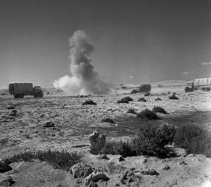 A shell bursts amongst the trucks of a New Zealand Army convoy