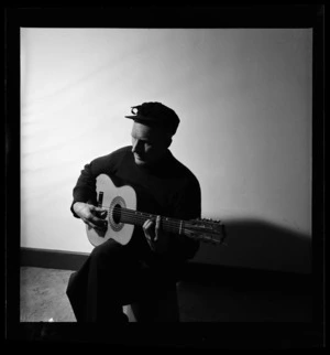 Portrait of Les Cleveland playing a guitar