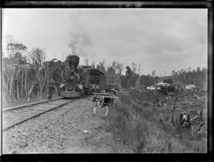 Unidentified railway workers on and around steam train pulled by a D class locomotive, unidentified rural area