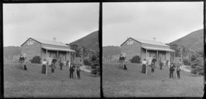 Unidentified group [family?] outside Campbell's house, Cannibal Bay, Clutha District, Otago Region