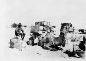 Camel and men in the desert, Palestine