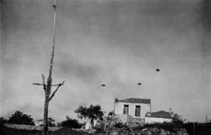 Scene in Galatos, Crete, showing 3 German paratroopers in the sky
