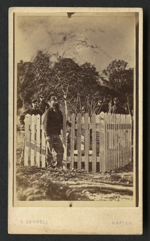 Carnell, Samuel 1832-1920 : Photograph of unidentified man dressed in uniform with other uniformed men in background