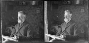 John Campbell reading book in living room, location unknown