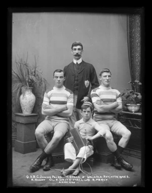 Team photograph of the Junior Pairs team, Queens Drive Boat Club, with their coach, 1st Otago, 2nd Waihola Regatta, 1905-1906.