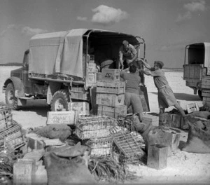 Soldiers loading a truck with a unit's rations at an Army Service Corps supply depot, Egypt