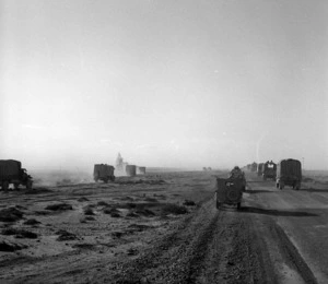 Photograph of convoy crossing the desert, taken just as one hits a land mine