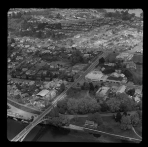 Hamilton with bridge over Waikato River in foreground and also showing the premises of Waikato Breweries Ltd and C L Innes and Co Ltd