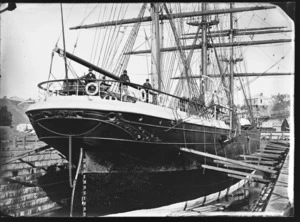 View of the stern of the sailing ship 'Dunedin' in the graving dock at Port Chalmers