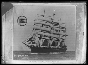 The sailing ship 'Star of Lapland' under full sail in the open sea. The house flag of the Alaska Packers Association is inserted in the top left hand corner