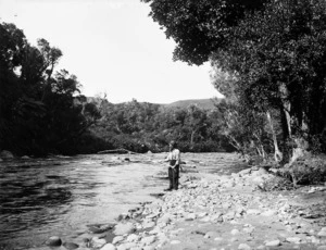 Man fishing on a river bank