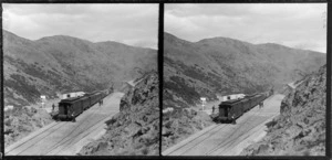 A train stopped on the railway tracks, with passengers standing alongside, Taieri Gorge, Central Otago