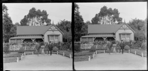 Two men standing next to a sun dial in front of the Curator's House, Christchurch Botanic Gardens