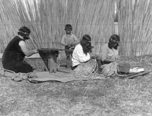 Maori women making piupiu and taniko