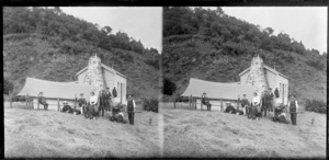 Group including William, Owen, and Edgar Williams, Mr Murray and Mr Thompson, after rabbit shooting trip, outside wooden cottage with tent pitched alongside, Murdering Beach, Otago