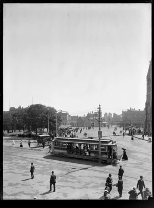 Cathedral Square, Christchurch, including tram shelter, tram, a horse-drawn carriage, and people walking