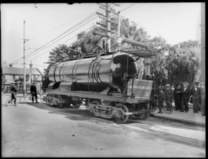 Christchurch Tramways vehicle lubricating bends in tramline, surrounded by male spectators