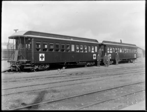 Unidentified group of men standing alongside a Thomas tranmission rail motor car, which is in use as a hospital train, [Christchurch?]