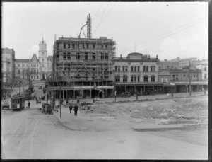 Corner of Wellesley and Queen Streets, Auckland, featuring a vacant lot, businesses including Tonson Garlick Company Ltd, and Auckland Public Library Art Gallery and Municipal Offices