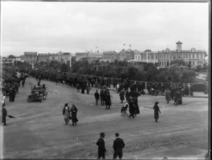 Military parade, The Square, Palmerston North, showing mounted regiment troops and spectators, and including business premises of Watson Brothers, Millar & Giorgi clothiers and boot specialists, and the Occidental Hotel