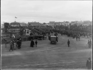World War I parade, The Square, Palmerston North, showing mounted regiment, gardens, band rotunda, and businesses including Watson Brothers and Millar & Giorgi clothiers and boot specialists