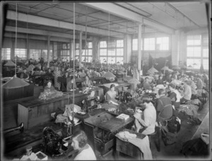 Clothing factory interior, showing female staff sewing garments on sewing machines, location unidentified