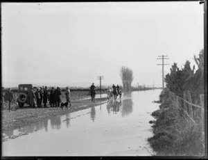 Traffic stopped on a rural road blocked by flood waters, possibly Canterbury region