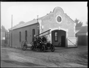 Scene outside local Fire Station, showing firemen with fire truck tender and hose reel, Christchurch