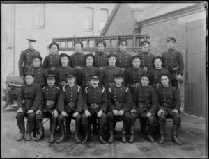 Group portrait of local Fire Brigade members in full uniform, beside Christchurch Fire Station