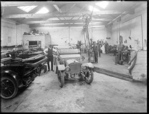 Inside an Argyll machinery shop, Central Hawke's Bay, showing men and motorcars
