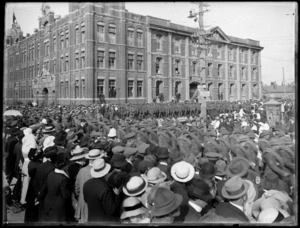 View of World War I soldiers on parade with crowds of people looking on, in front of Government Printing Office, Wellington