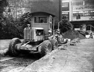 Road grader doing prepatory work for the building of an air raid shelter, Wakefield Street, Wellington