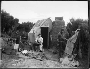Two gum diggers, including Josiah Hart Saies, working outside a hut
