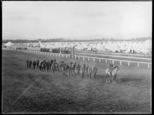New Zealand Infantry soldiers with horsemen soldiers on parade in camp, [Trentham, Upper Hutt?], with tents in the background