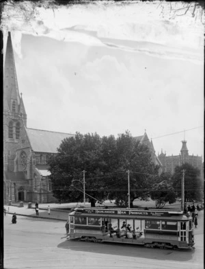 A double saloon tram carrying passengers at Cathedral Square, Christchurch