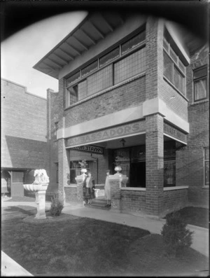 The front entrance of Hotel Ambassadors, Manchester Street, Christchurch, showing two unidentified women standing on front step